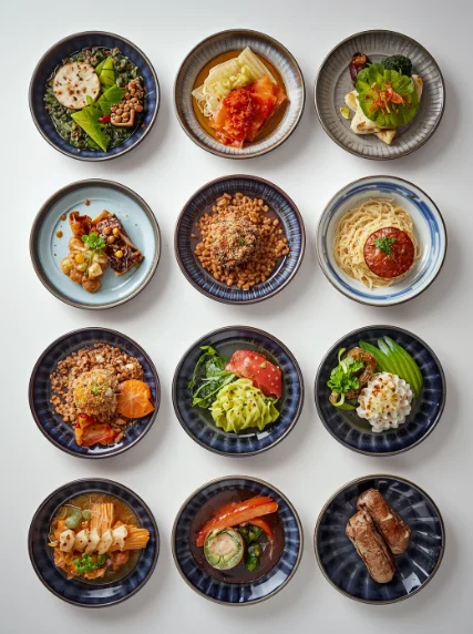 Small Japanese dishes in blue-rimmed bowls, arranged in rows