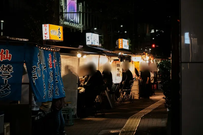 Yatai food stalls with lanterns and noren curtains at night in Fukuoka