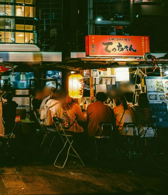 People eating at yatai food stalls in Tenjin at night